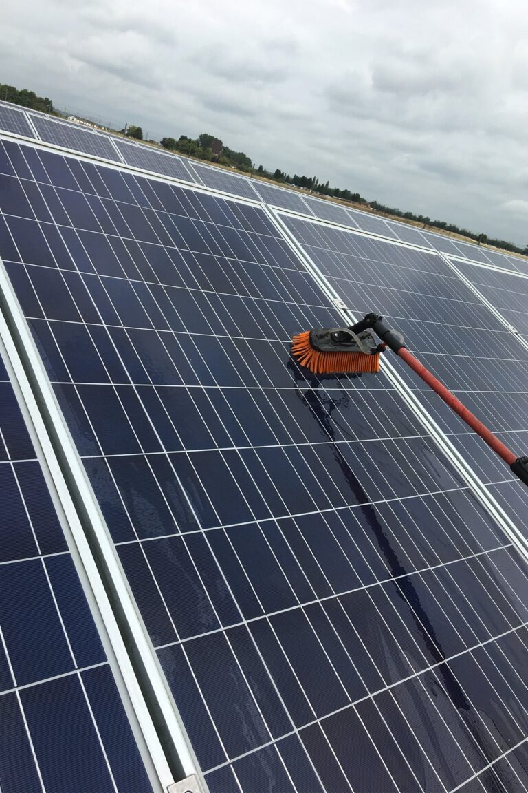 Solar panels on a rooftop in Leighton Buzzard being meticulously cleaned with a water-fed pole, ensuring thorough and safe cleaning